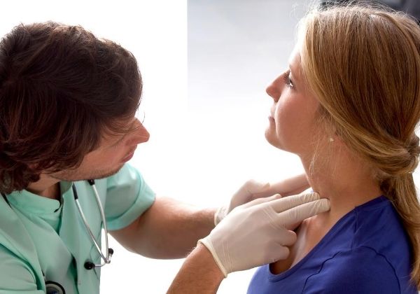 ENT doctor examining lymph nodes