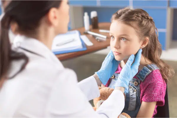 Young girl with dr examining neck - C/V ENT Surgical Group