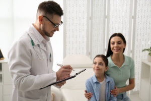 Mother with daughter visiting pediatrician in hospital